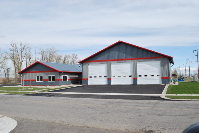 Gray and Red Striped Steel Garage Utilized as a fire station.