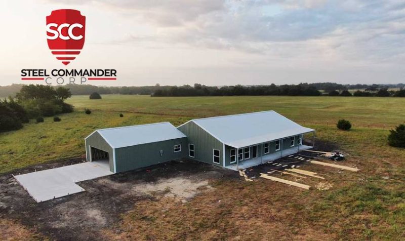 Green Steel Home with White Roof and Detached Two Car Steel Garage