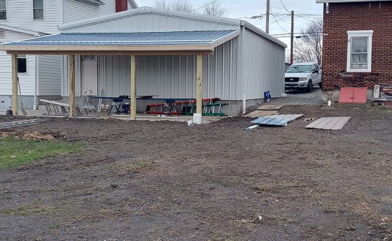 Exterior Back Side of Residential Steel Home with Overhang