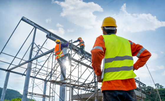 Engineer watching the construction of a steel building