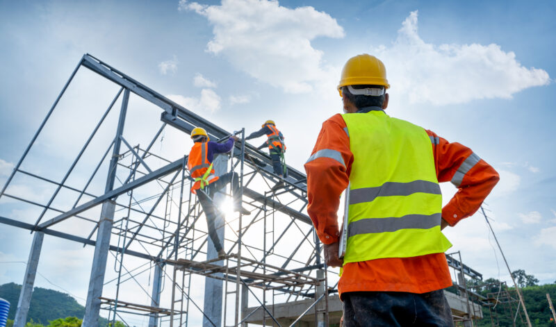 Engineer watching the construction of a steel building